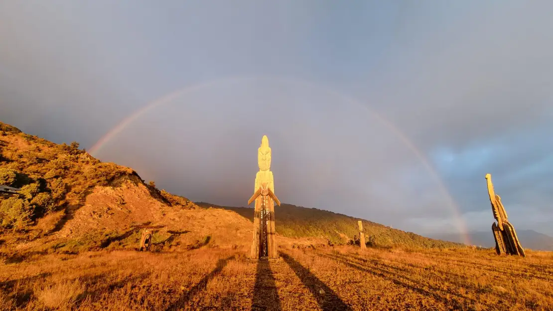 Sunrise view with Maori carvings
